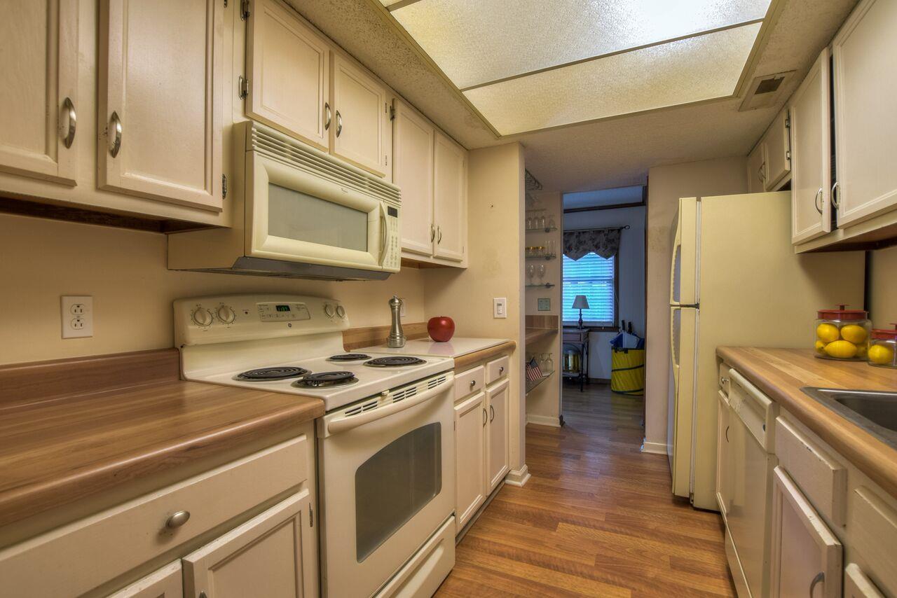 4001 Anderson Road, Unit B128 Nashville, TN 37217 - Photo 13 of 21 a kitchen with stainless steel appliances granite countertop a stove and a refrigerator