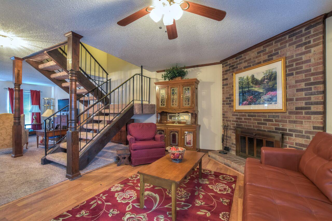 4001 Anderson Road, Unit B128 Nashville, TN 37217 - Photo 4 of 21 a living room with fireplace furniture and a wooden floor