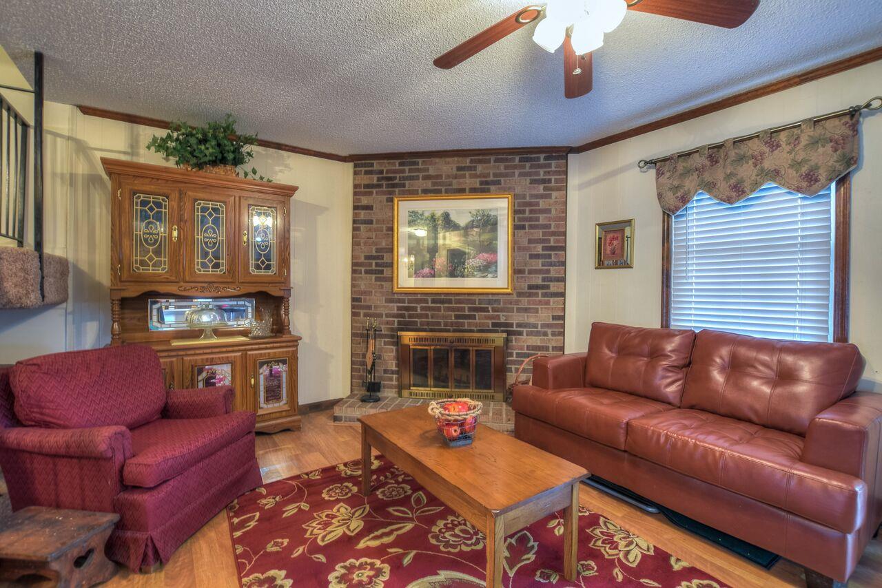 4001 Anderson Road, Unit B128 Nashville, TN 37217 - Photo 5 of 21 a living room with furniture a fireplace and a flat screen tv