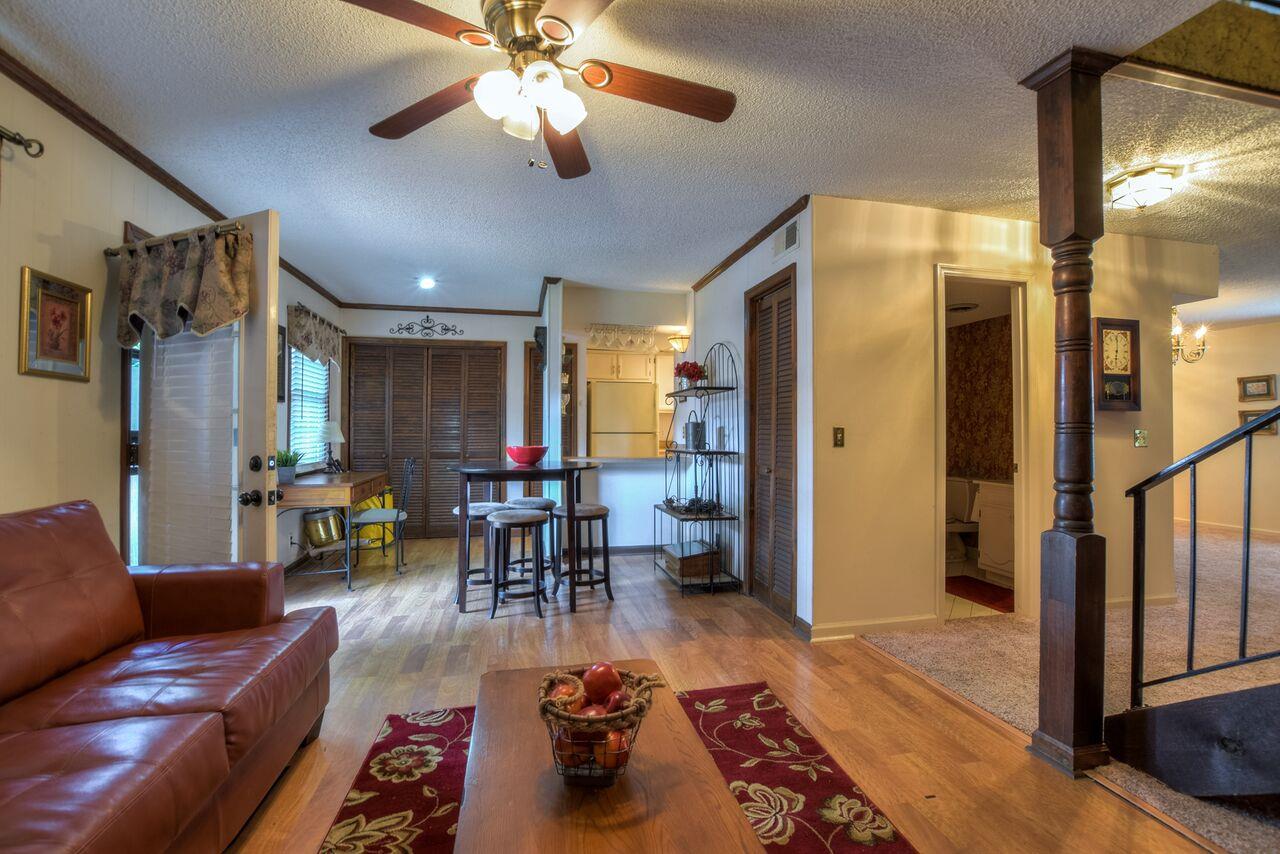 4001 Anderson Road, Unit B128 Nashville, TN 37217 - Photo 6 of 21 a living room with furniture and a chandelier