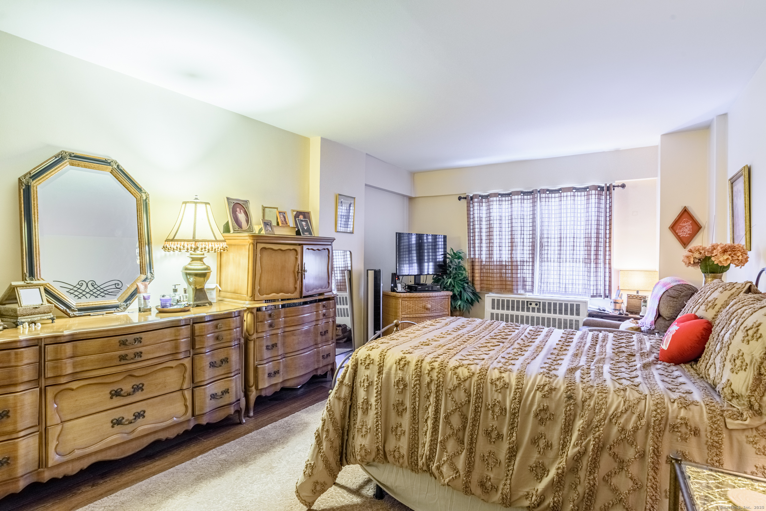 80 Cartright Street, Unit 5D Bridgeport, CT 06604 - Photo 14 of 24 a bed sitting in a bedroom and a dresser