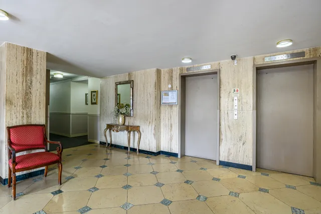 a spacious bathroom with a mirror a toilet and a shower