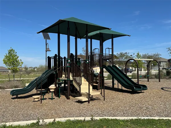 a view of a patio with table and chairs