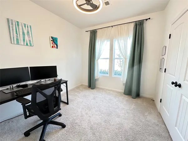 a large bed sitting in a bedroom next to a window