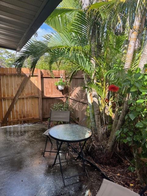 716 White Pine Tree Road, Unit 79 Venice, FL 34285 - Photo 14 of 22 a backyard of a house with table and chairs
