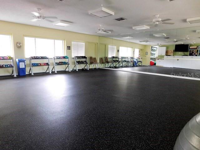 716 White Pine Tree Road, Unit 79 Venice, FL 34285 - Photo 22 of 22 a room with lots of wooden furniture and a view of living room