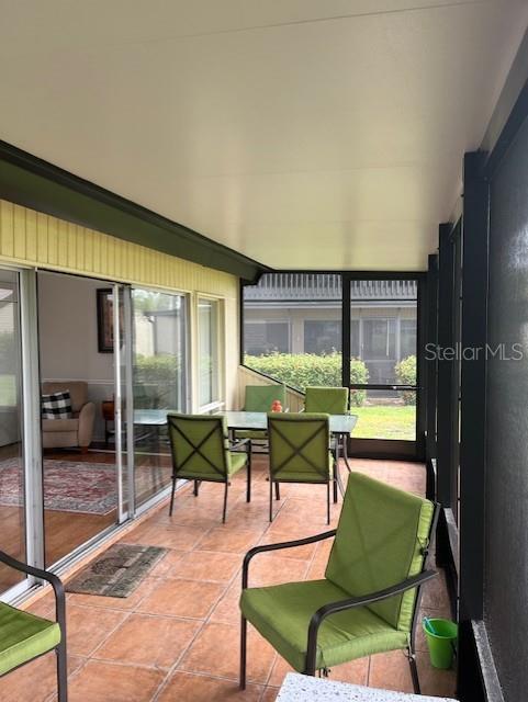 716 White Pine Tree Road, Unit 79 Venice, FL 34285 - Photo 10 of 22 a living room with furniture and a floor to ceiling window