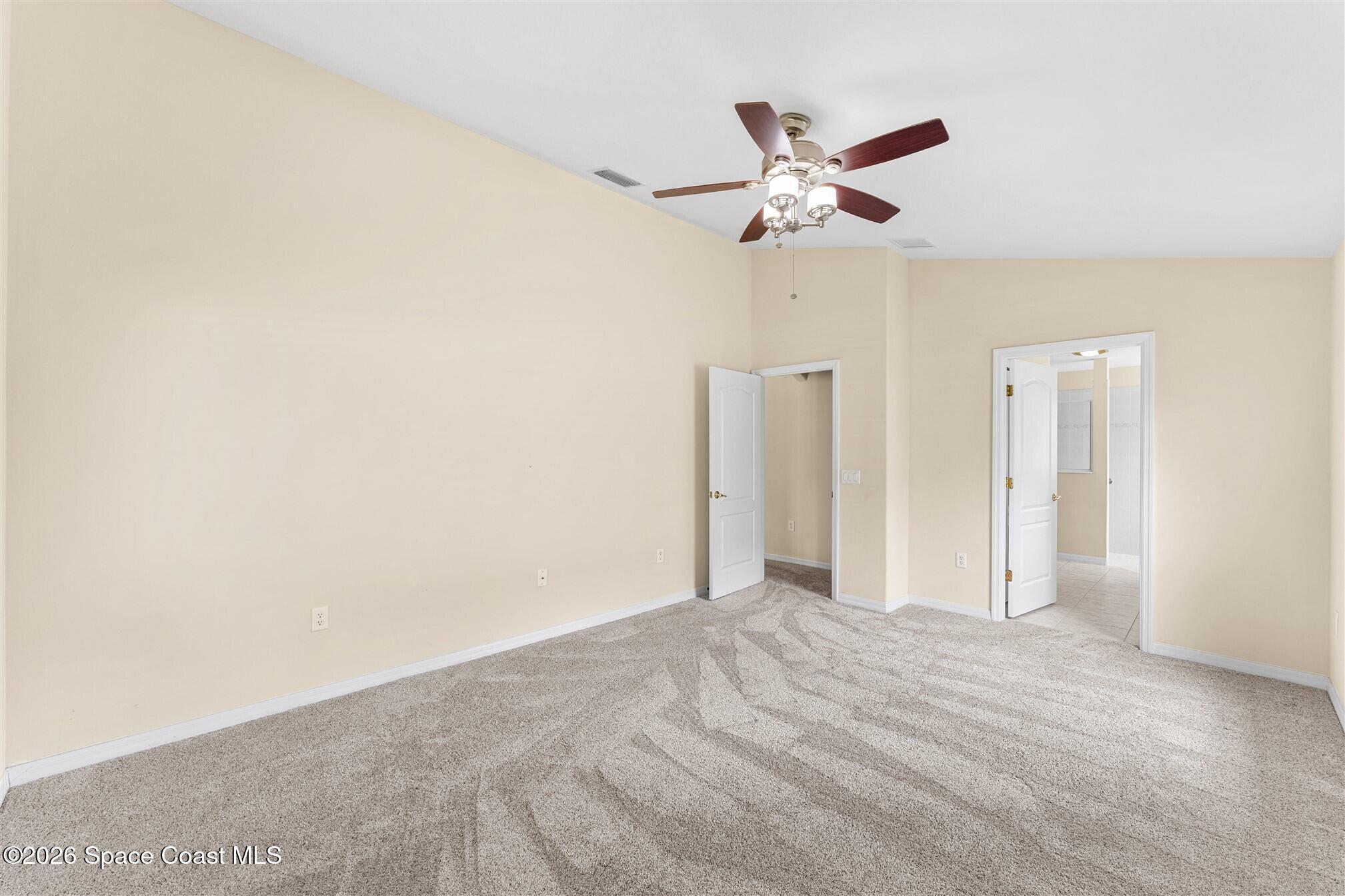 6904 Renshaw Drive Melbourne, FL 32940 - Photo 21 of 46 a view of a livingroom with a ceiling fan and wooden floor