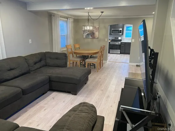 a living room with furniture and a chandelier