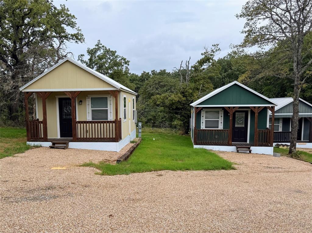 5001 Knob Hill Road, Unit D2D5 Azle, TX 76020 - Photo 15 of 16 a view of a house with a yard and large trees