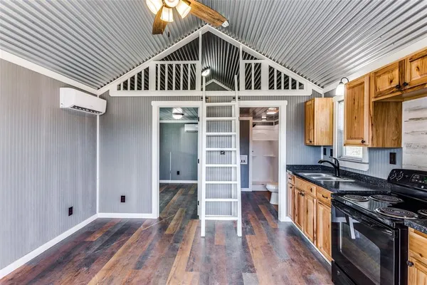 a view of a kitchen with wooden floor and a ceiling fan
