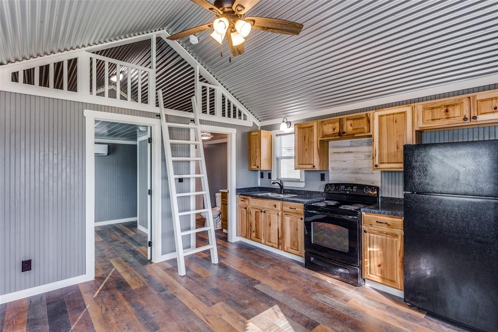 5001 Knob Hill Road, Unit D2D5 Azle, TX 76020 - Photo 4 of 16 a kitchen with stainless steel appliances granite countertop a stove and a refrigerator
