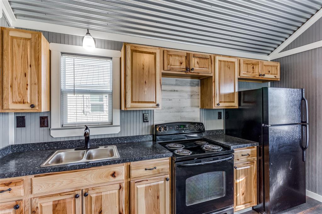 5001 Knob Hill Road, Unit D2D5 Azle, TX 76020 - Photo 6 of 16 a kitchen with granite countertop a sink stainless steel appliances and cabinets