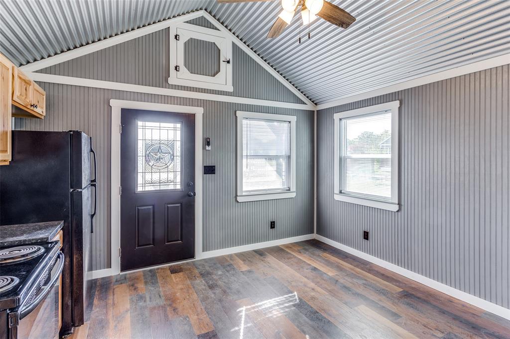 5001 Knob Hill Road, Unit D2D5 Azle, TX 76020 - Photo 7 of 16 a view of a hallway with wooden floor and a kitchen