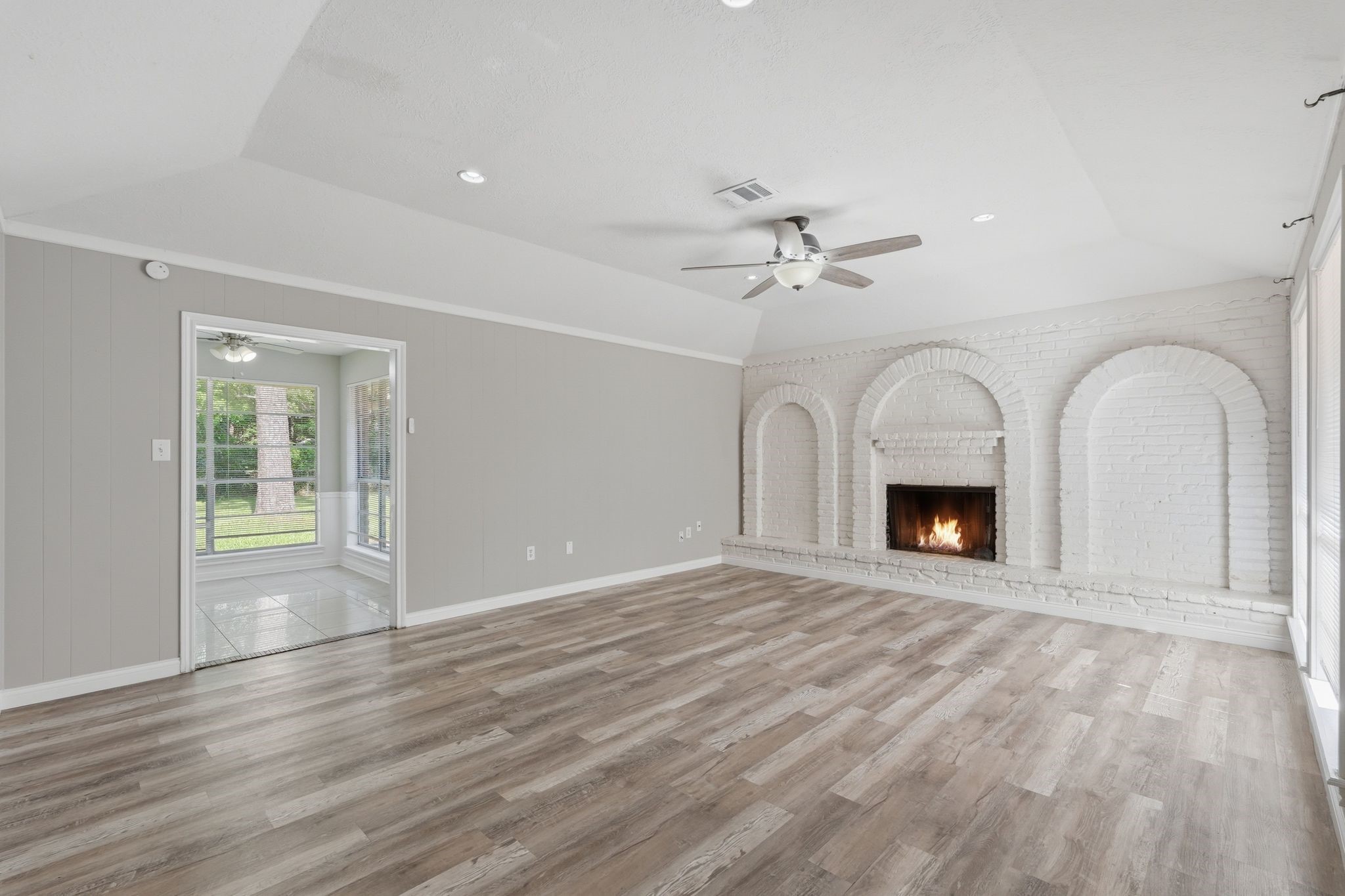 25611 Timberlane Drive Spring, TX 77386 - Photo 12 of 38 a view of empty room with fireplace and wooden floor