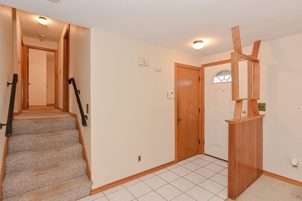209 3rd Street Stoughton, MA 02072 - Photo 15 of 36 a view of a hallway with wooden floor and staircase