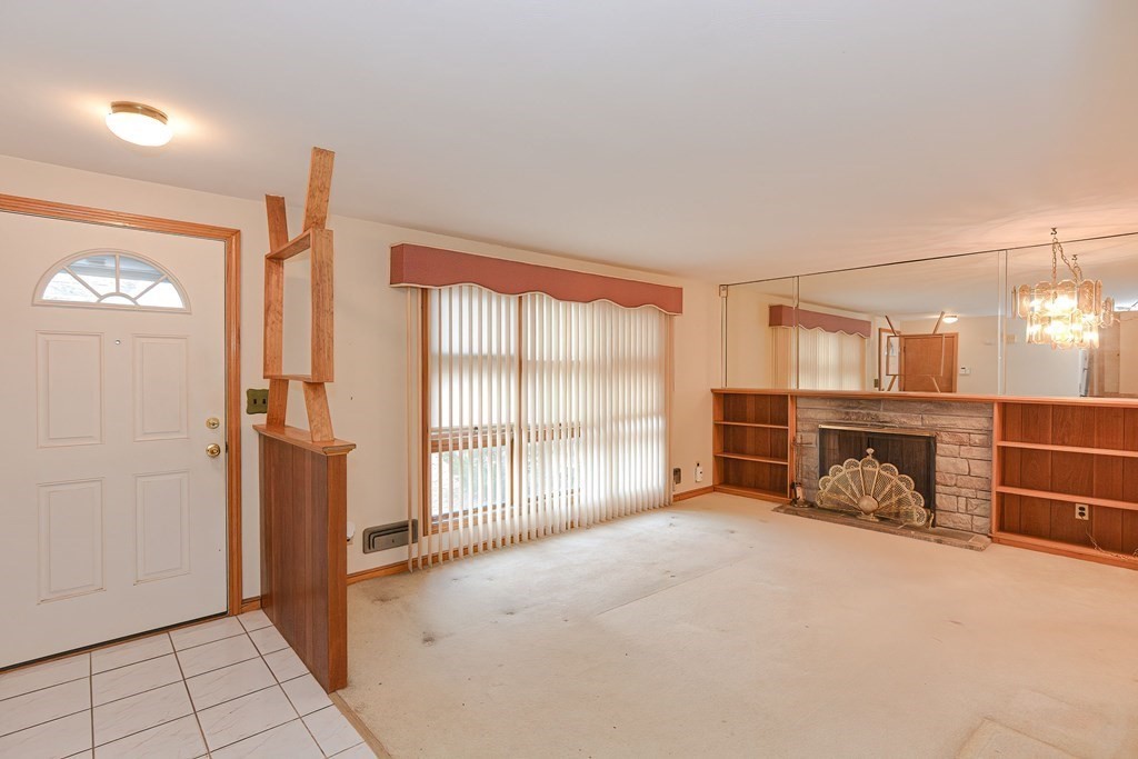 209 3rd Street Stoughton, MA 02072 - Photo 17 of 36 an empty room with fireplace and windows