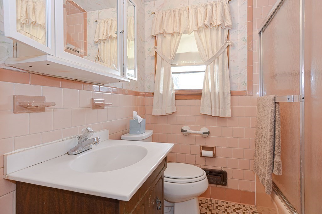 209 3rd Street Stoughton, MA 02072 - Photo 19 of 36 a bathroom with a sink a toilet and a mirror