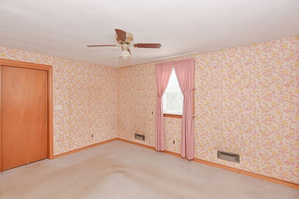 209 3rd Street Stoughton, MA 02072 - Photo 20 of 36 an empty room with a ceiling fan and a window