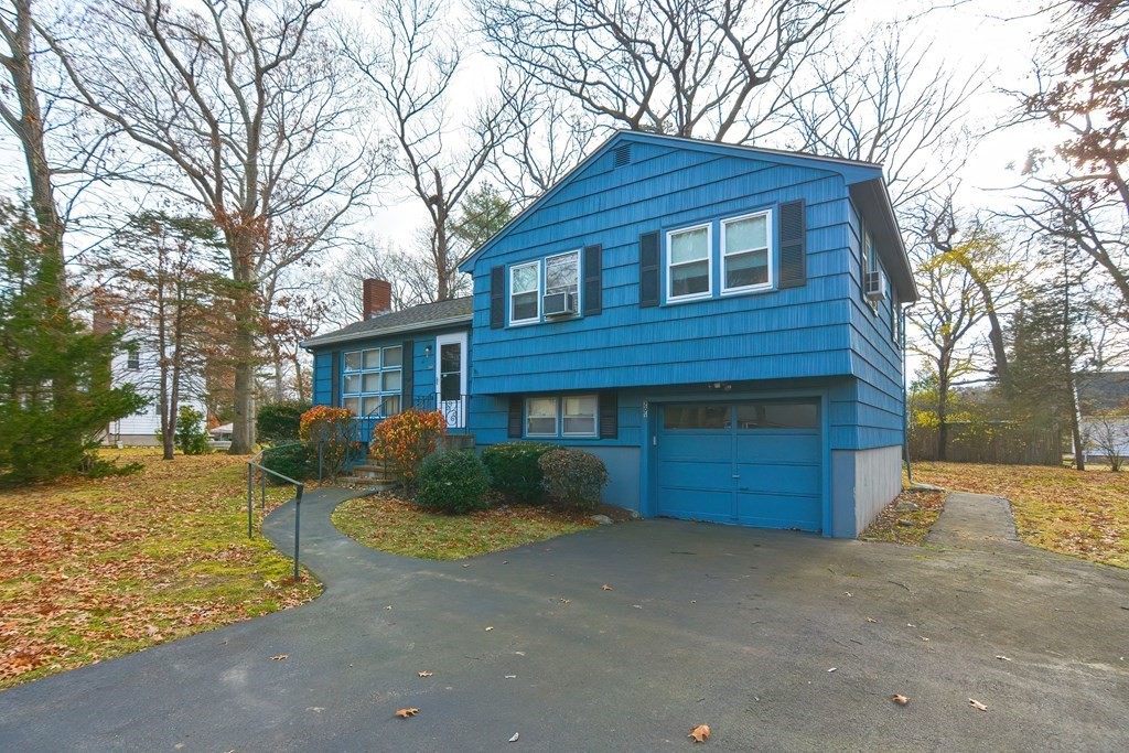 209 3rd Street Stoughton, MA 02072 - Photo 2 of 36 a front view of a house with a yard and garage