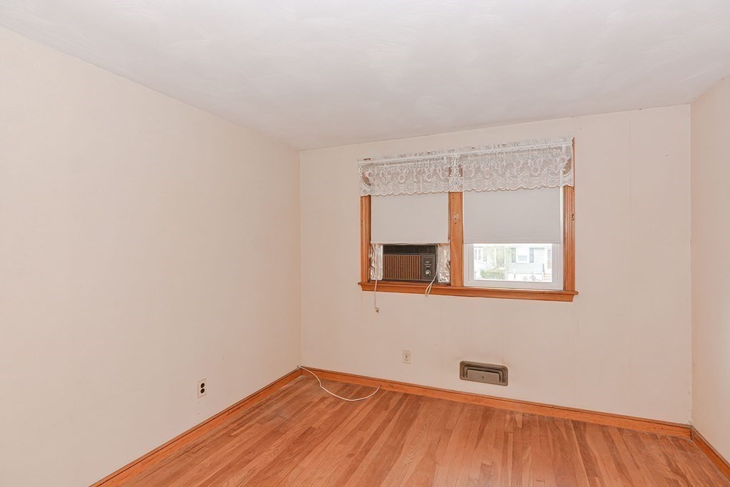 209 3rd Street Stoughton, MA 02072 - Photo 22 of 36 a view of a room with wooden floor and a window