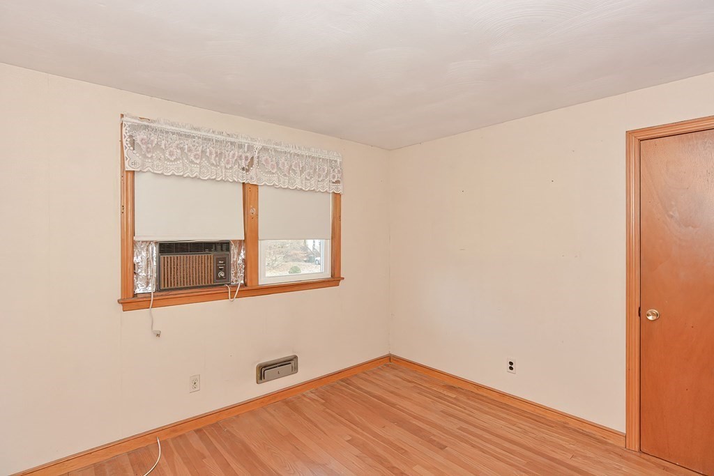 209 3rd Street Stoughton, MA 02072 - Photo 23 of 36 a view of an empty room with wooden floor and a window