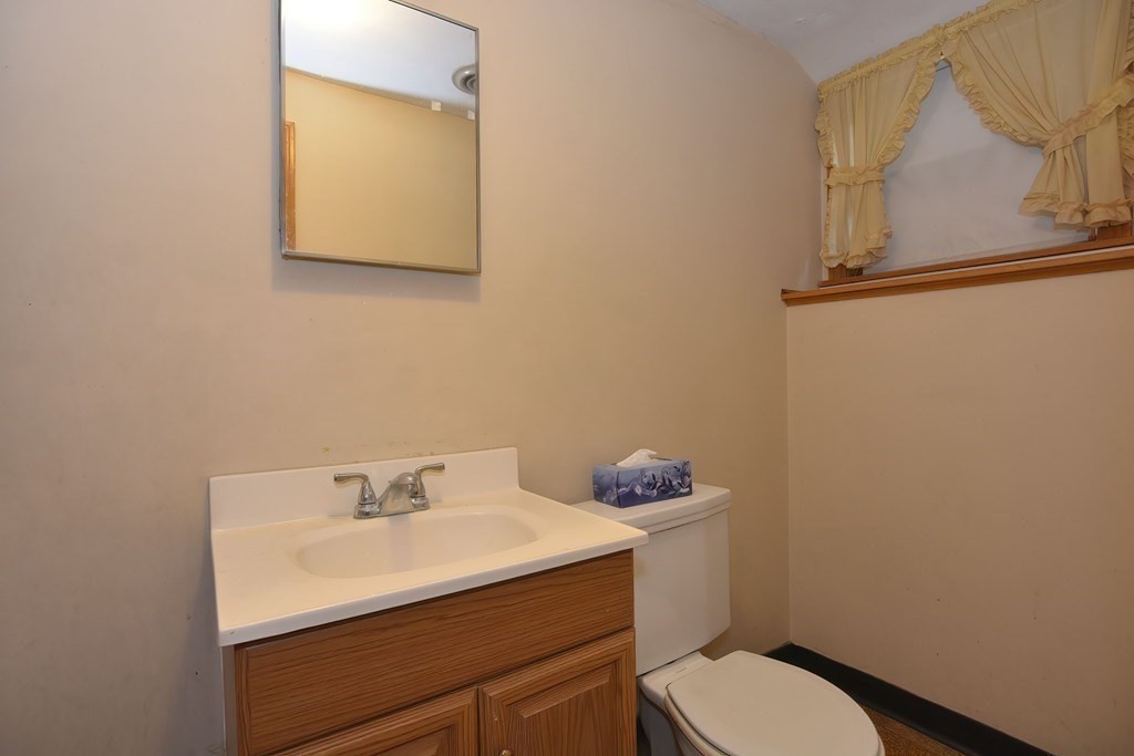 209 3rd Street Stoughton, MA 02072 - Photo 29 of 36 a bathroom with a sink mirror and toilet