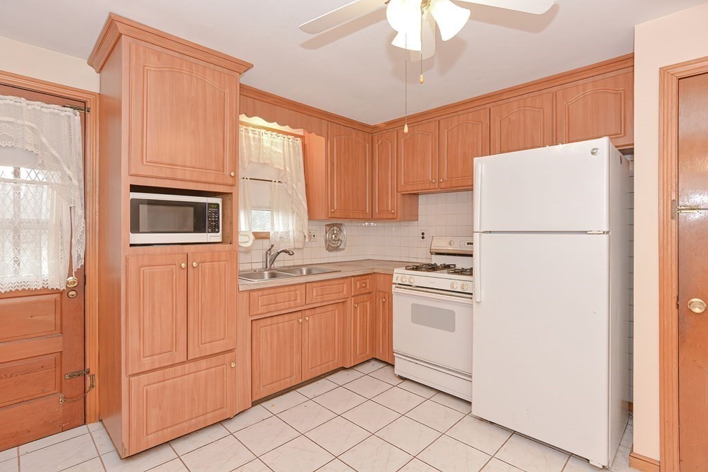 209 3rd Street Stoughton, MA 02072 - Photo 3 of 36 a kitchen with stainless steel appliances granite countertop a refrigerator a stove a sink and dishwasher