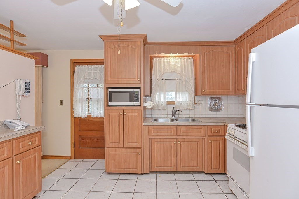 209 3rd Street Stoughton, MA 02072 - Photo 5 of 36 a kitchen with cabinets appliances and a window