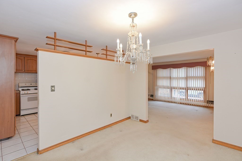 209 3rd Street Stoughton, MA 02072 - Photo 9 of 36 a view of a refrigerator in kitchen and an empty room