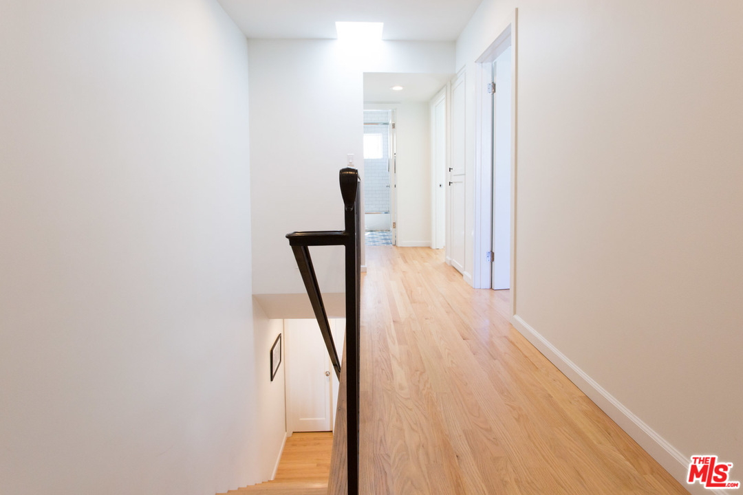 631 Strand Street, Unit 2 Santa Monica, CA 90405 - Photo 20 of 30 a view of a hallway with wooden floor and staircase