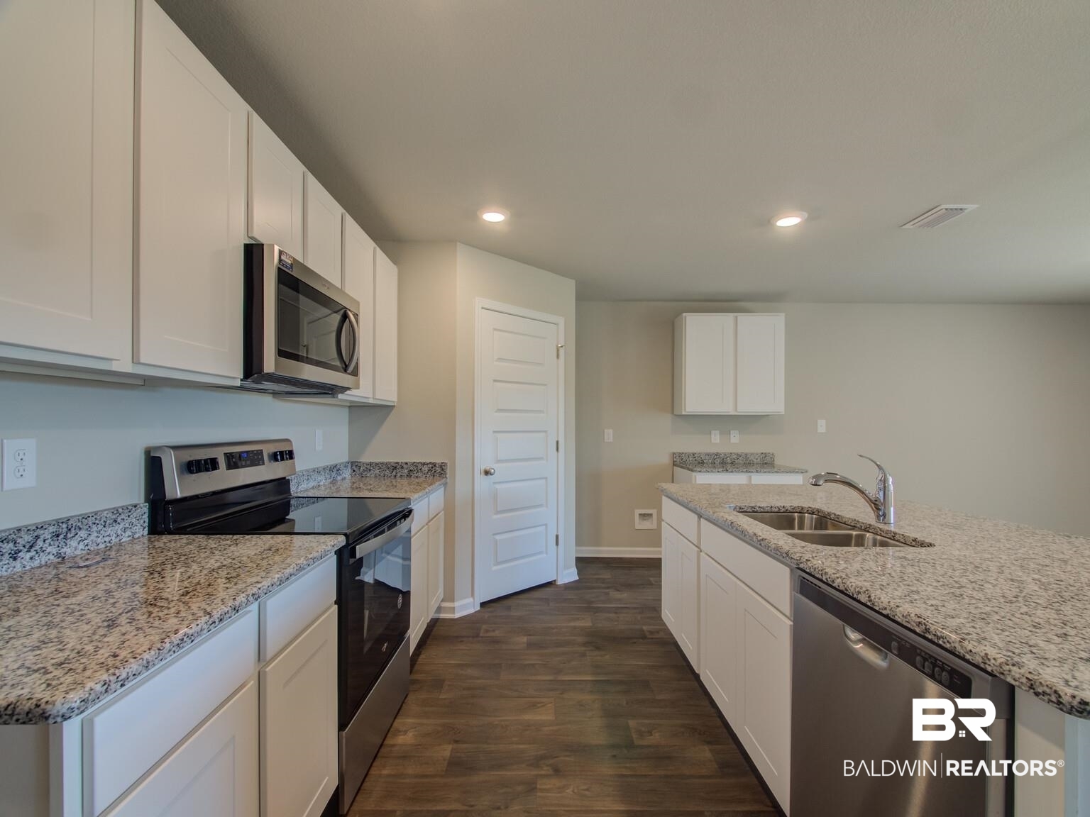 23953 Citation Loop Daphne, AL 36526 - Photo 13 of 49 Kitchen with stainless steel appliances, white cabinets, recessed lighting, light stone countertops, and dark wood-type flooring