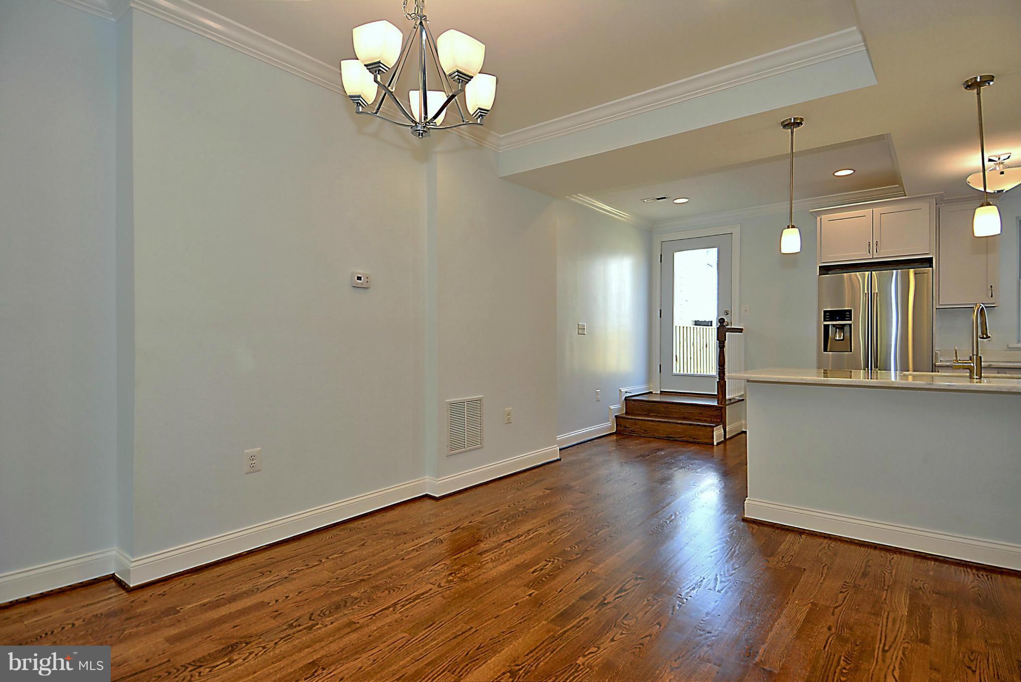 1102 4th Street Northeast Washington, DC 20002 - Photo 5 of 17 an empty room with wooden floor and windows