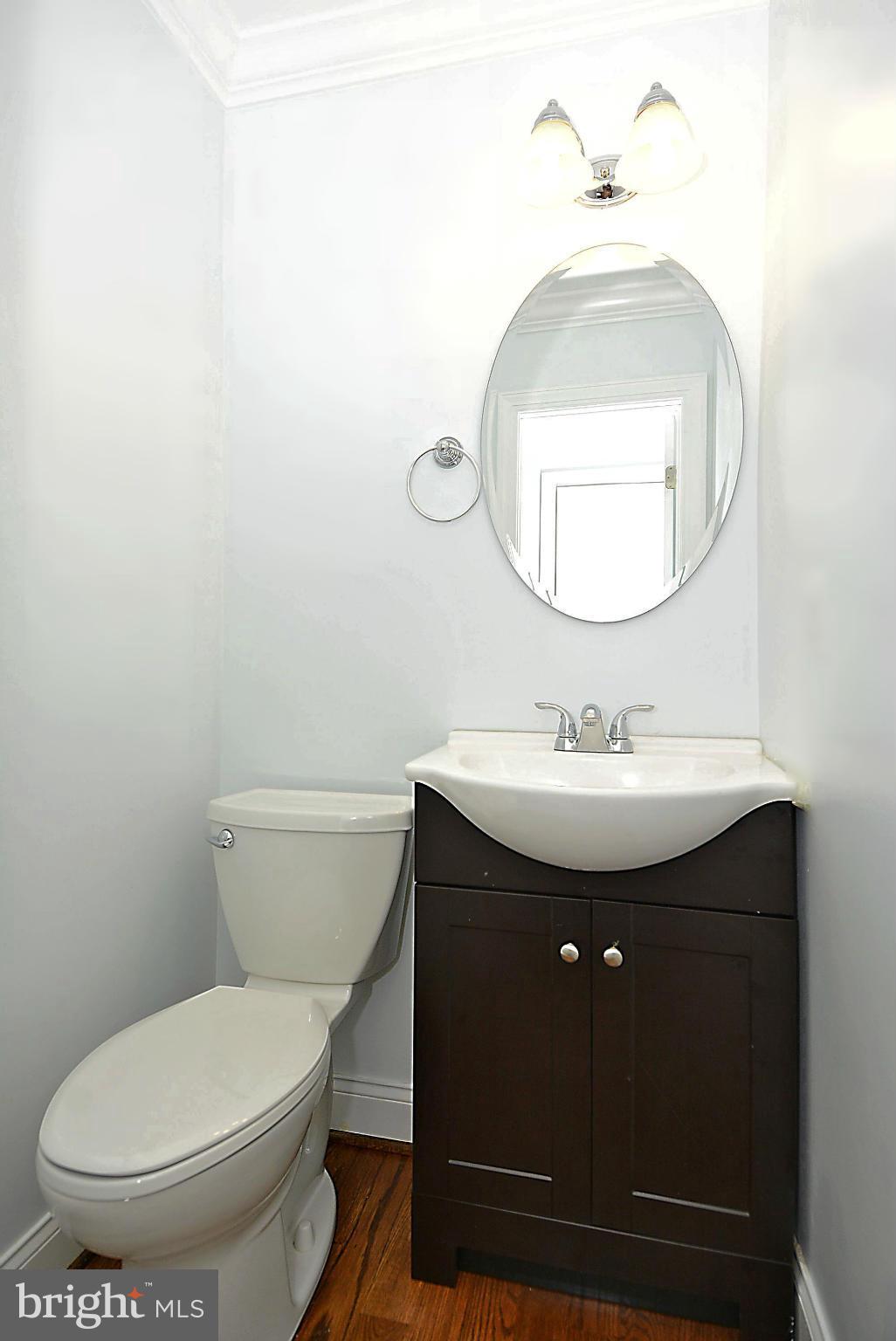 1102 4th Street Northeast Washington, DC 20002 - Photo 7 of 17 a bathroom with a sink toilet and a mirror