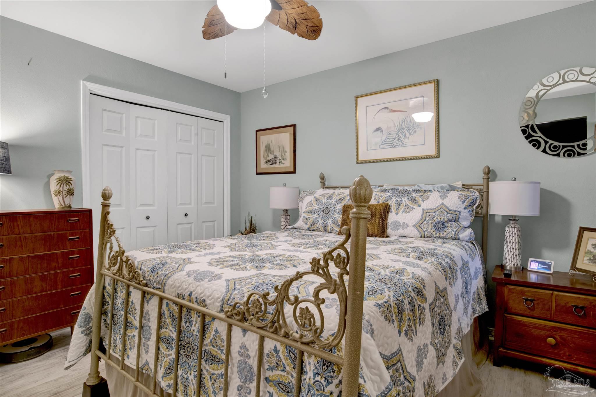 13351 Johnson Beach Road, Unit 203E Perdido Key, FL 32507 - Photo 20 of 55 a bedroom with a bed and wooden floor