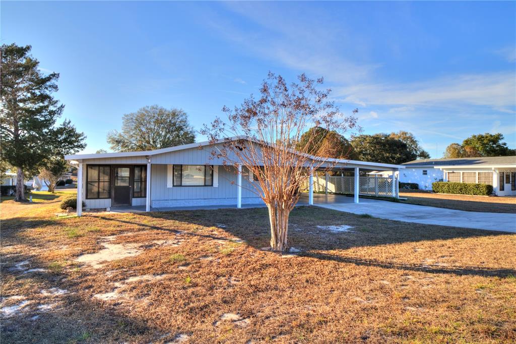 10182 Southwest 87th Terrace Ocala, FL 34481 - Photo 22 of 26 a front view of a house with a yard