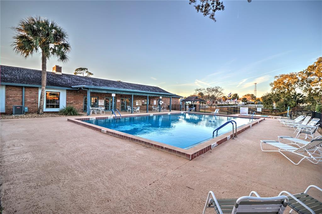10182 Southwest 87th Terrace Ocala, FL 34481 - Photo 24 of 26 a view of swimming pool with a yard and seating space