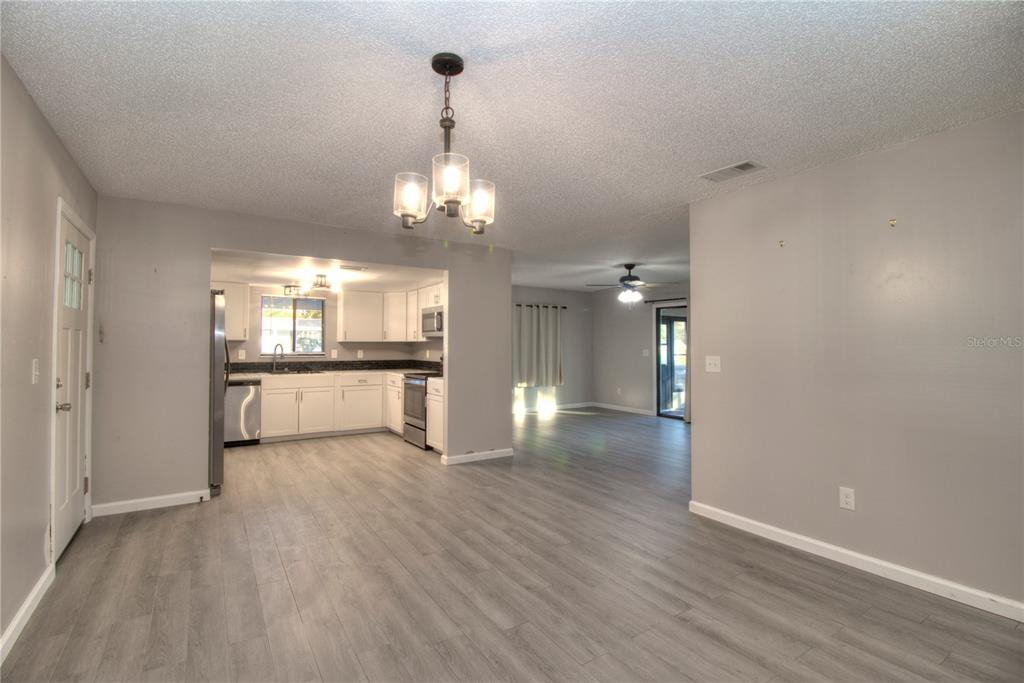 10182 Southwest 87th Terrace Ocala, FL 34481 - Photo 3 of 26 a view of a kitchen with a sink and wooden floor