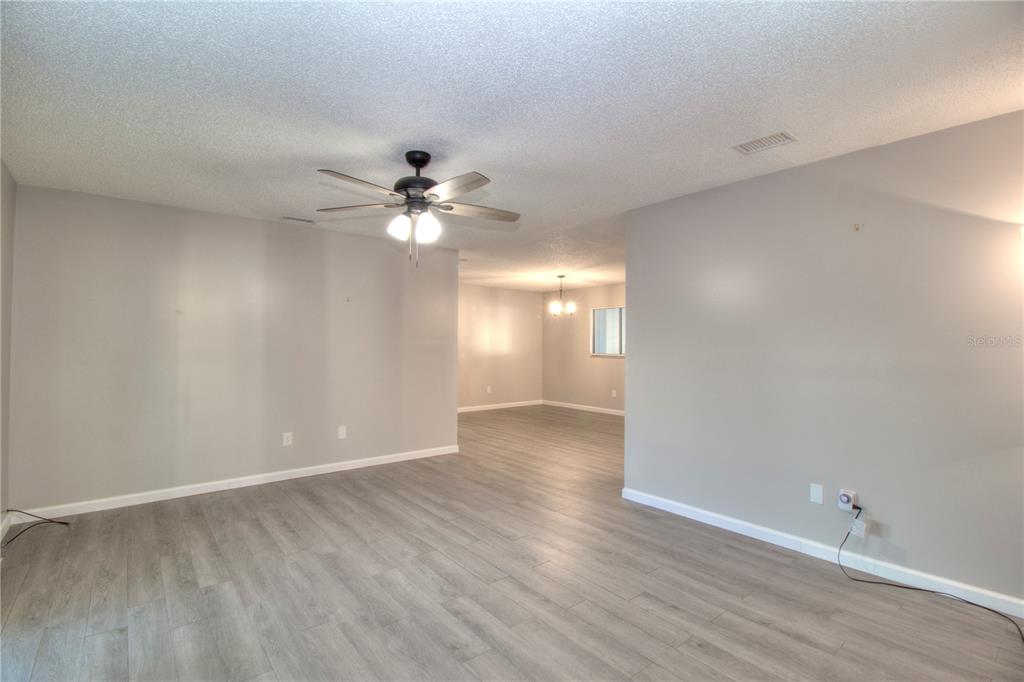 10182 Southwest 87th Terrace Ocala, FL 34481 - Photo 8 of 26 a view of an empty room with a chandelier fan