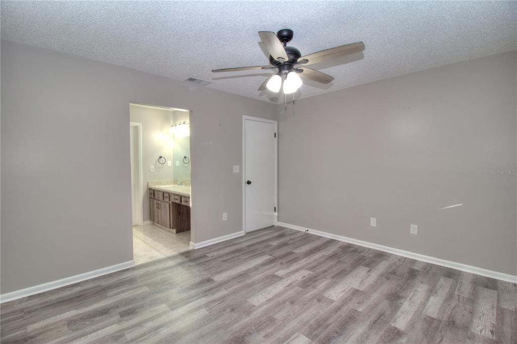 10182 Southwest 87th Terrace Ocala, FL 34481 - Photo 9 of 26 a view of a hallway with a chandelier fan