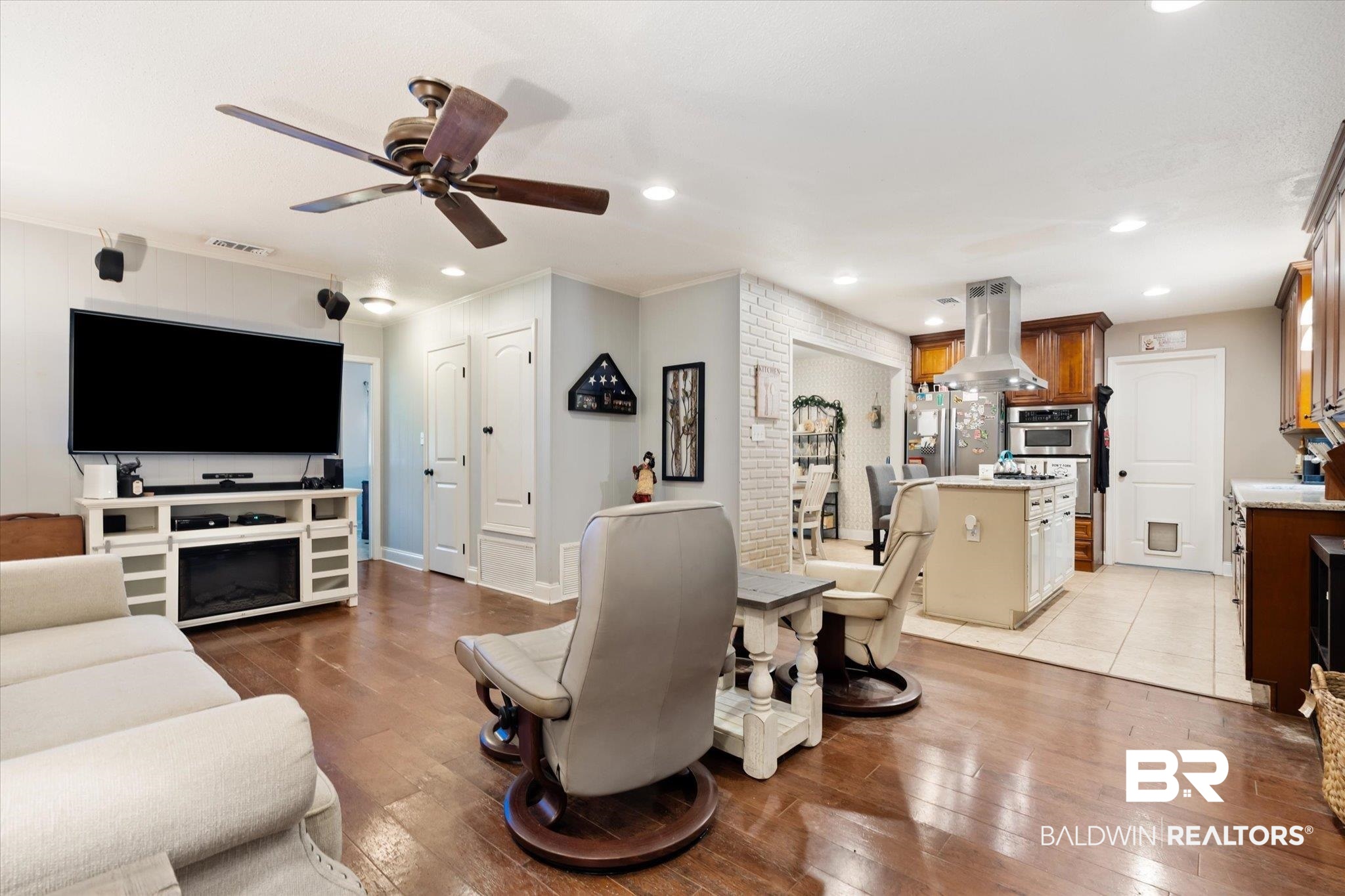 558 Stuart Street Daphne, AL 36526 - Photo 3 of 29 Living room featuring a fireplace, ceiling fan, and light wood-type flooring