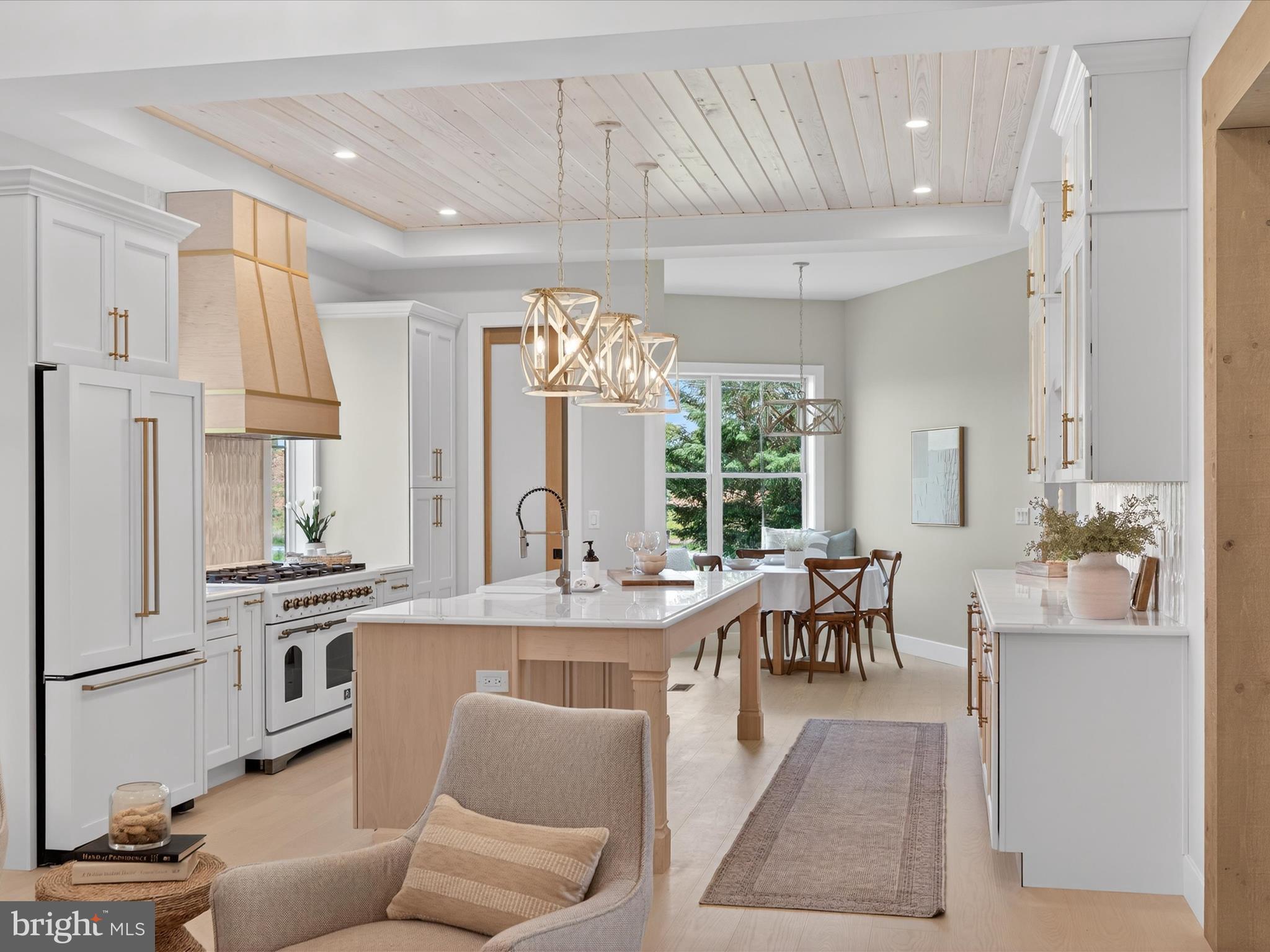 297 Sarsen Drive Lititz, PA 17543 - Photo 18 of 67 a dining hall with stainless steel appliances granite countertop a stove a refrigerator a oven a dining table and chairs with wooden floor