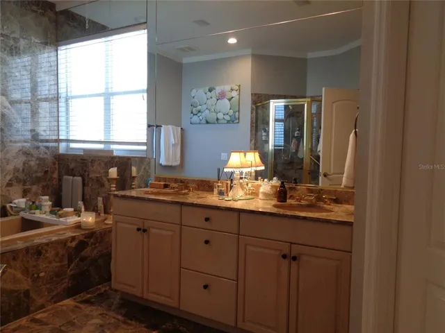 a bathroom with a double vanity sink and a mirror