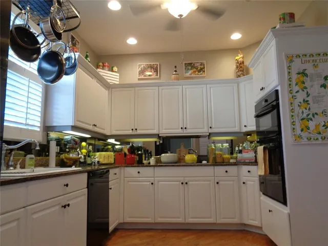 a kitchen with stainless steel appliances granite countertop a sink a stove and a refrigerator