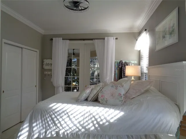 a bedroom with a large bed and a window
