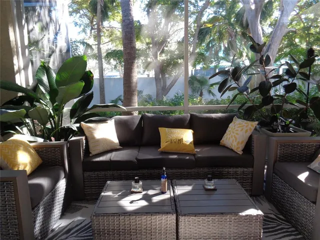 a view of a couches in the patio next to a yard