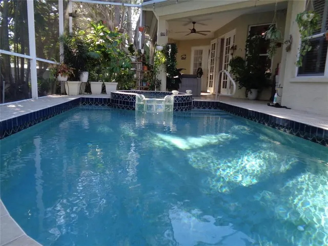a view of a house with swimming pool and porch