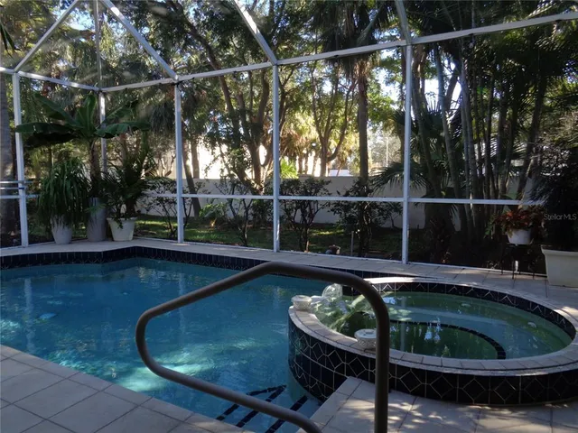 a view of a house with a tree and plants