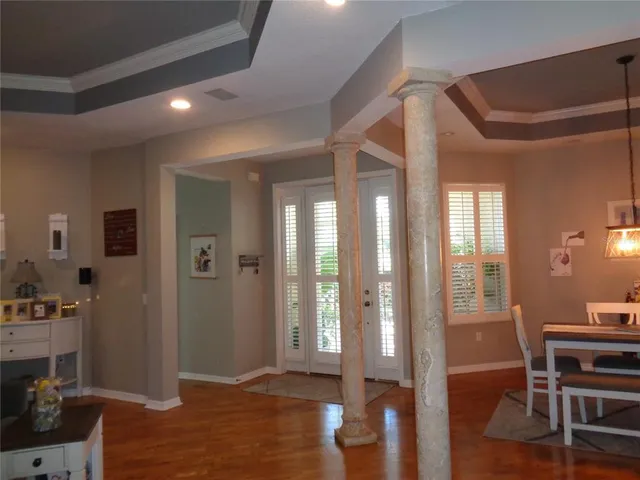 a view of a hallway and dining room with wooden floor