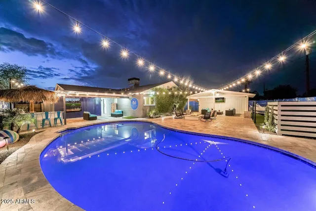 a view of swimming pool with a table and chairs